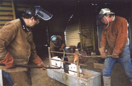Tim Nimmo of Crow Atelier pouring molton bronze for Sumichrast's "Swimmer".